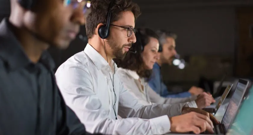 Customer service representative answering business calls using a headset.